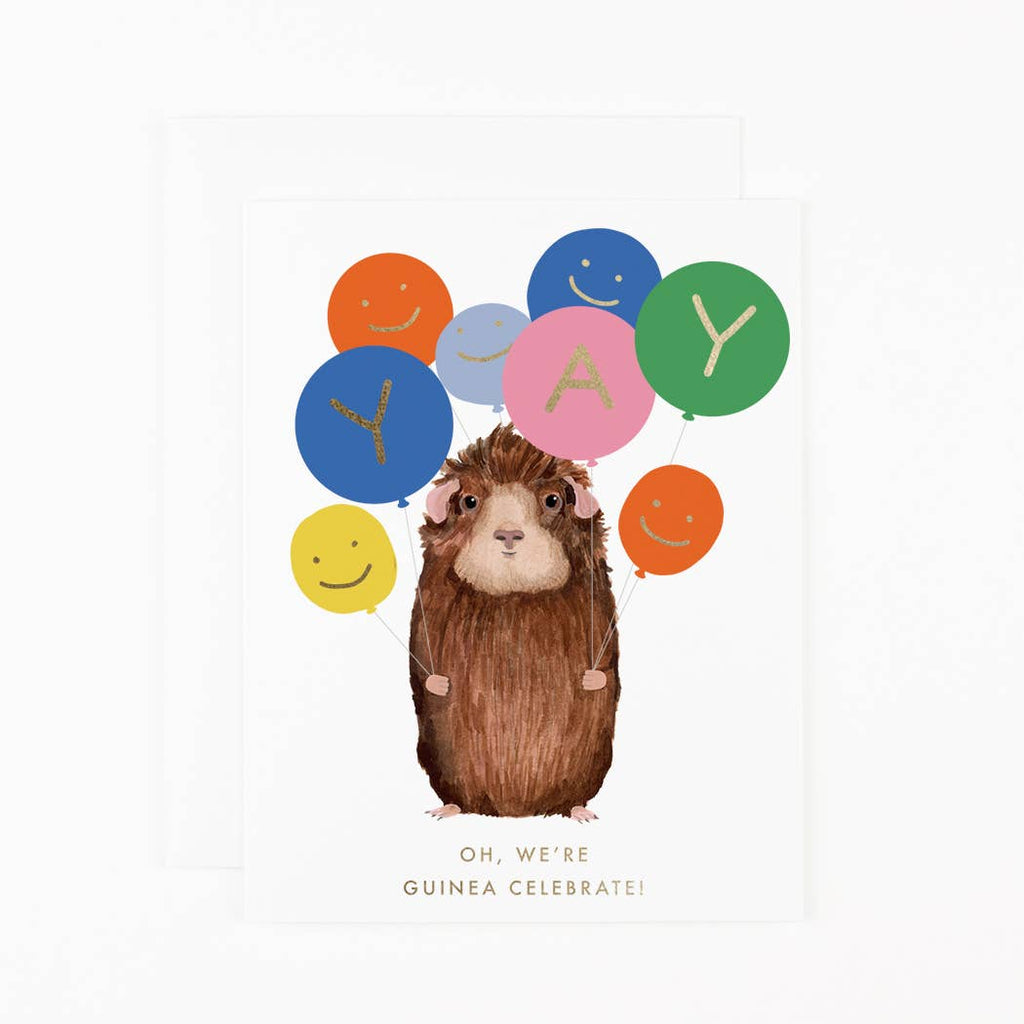 Greeting card with white background and image of a brown guinea pig holding a bunch of balloons with gold foil text says, "YAY" and "Oh, we're guinea celebrate!". Envelope included. 