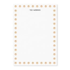 Image of notepad page with white background and images of upside down smiley faces on border and black text at top says, "Yes worries".
