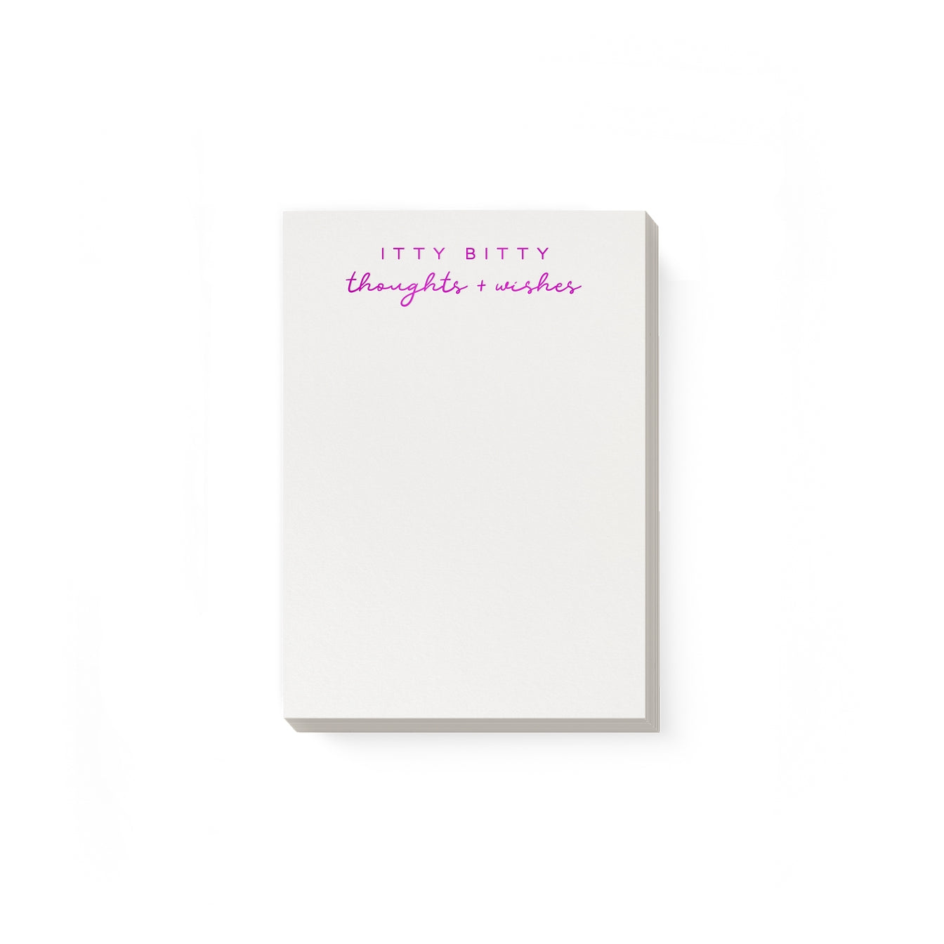 Notepad with white background and magenta foil text says, "Itty bitty thoughts + wishes". 