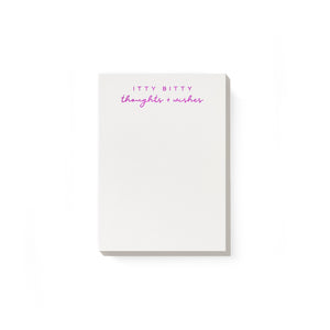 Notepad with white background and magenta foil text says, "Itty bitty thoughts + wishes". 