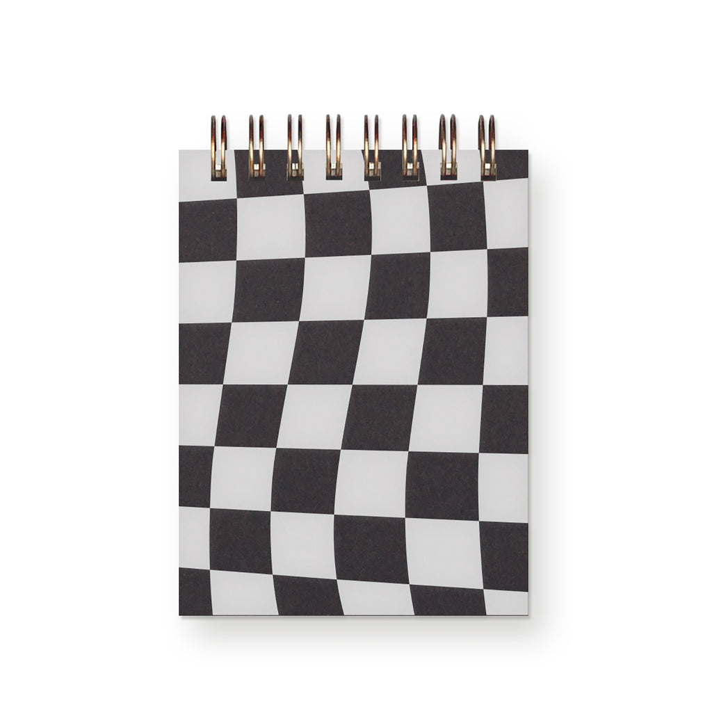 Notepad cover in black and white check pattern with coiled binding at the top. 
