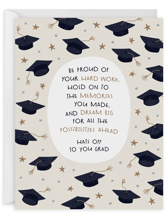 Greeting card with cream background with black graduation caps and gold stars with white oval at center with black and gold text says, "Be proud of your hard work, hold on to your memories you made, and dream big for all the possibilities ahead. Hats off to you grad". White envelope included. 