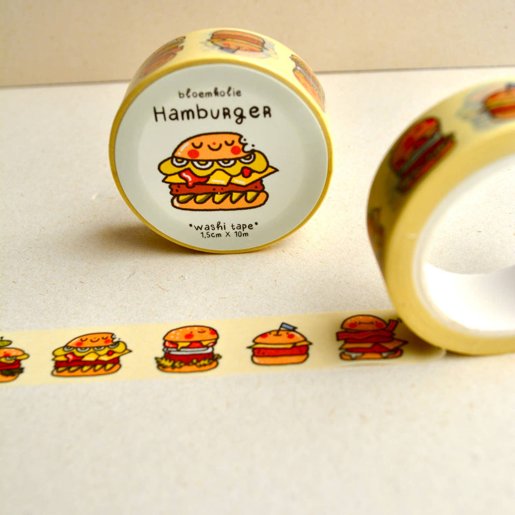 Image of roll of washi tape with pale yellow background with images of hamburgers on it.