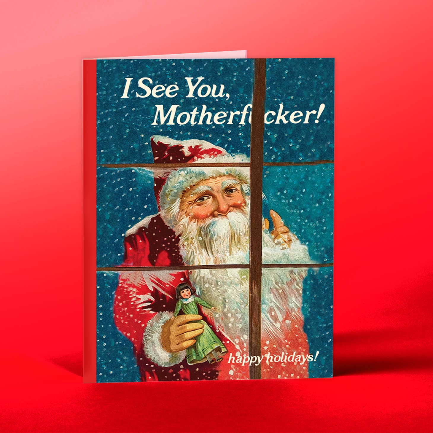 Blue and white snowy background with image of Santa Claus looking in the window holding a doll. White text says, "I see you, motherfucker! Happy holidays!". Envelope included. 