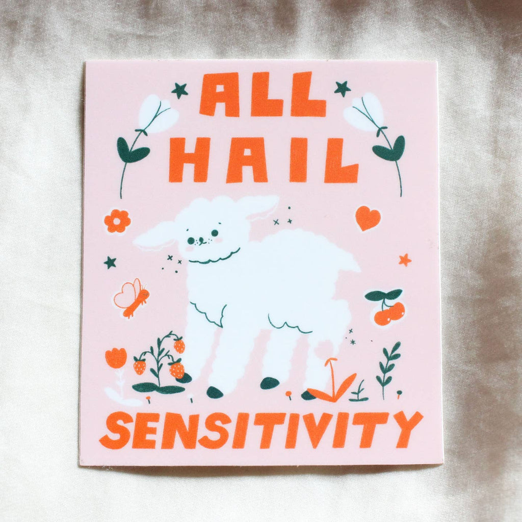 Sticker with pink background with image of white lamb with red text says, "All hail sensitivity". 