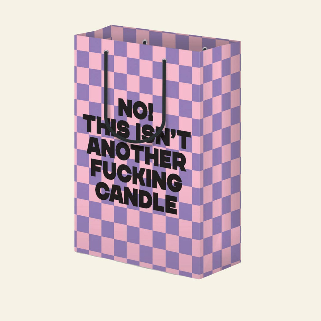Pink and lilac checkerboard background with black text says," No! This isn't another fucking candle". Black rope handle. 