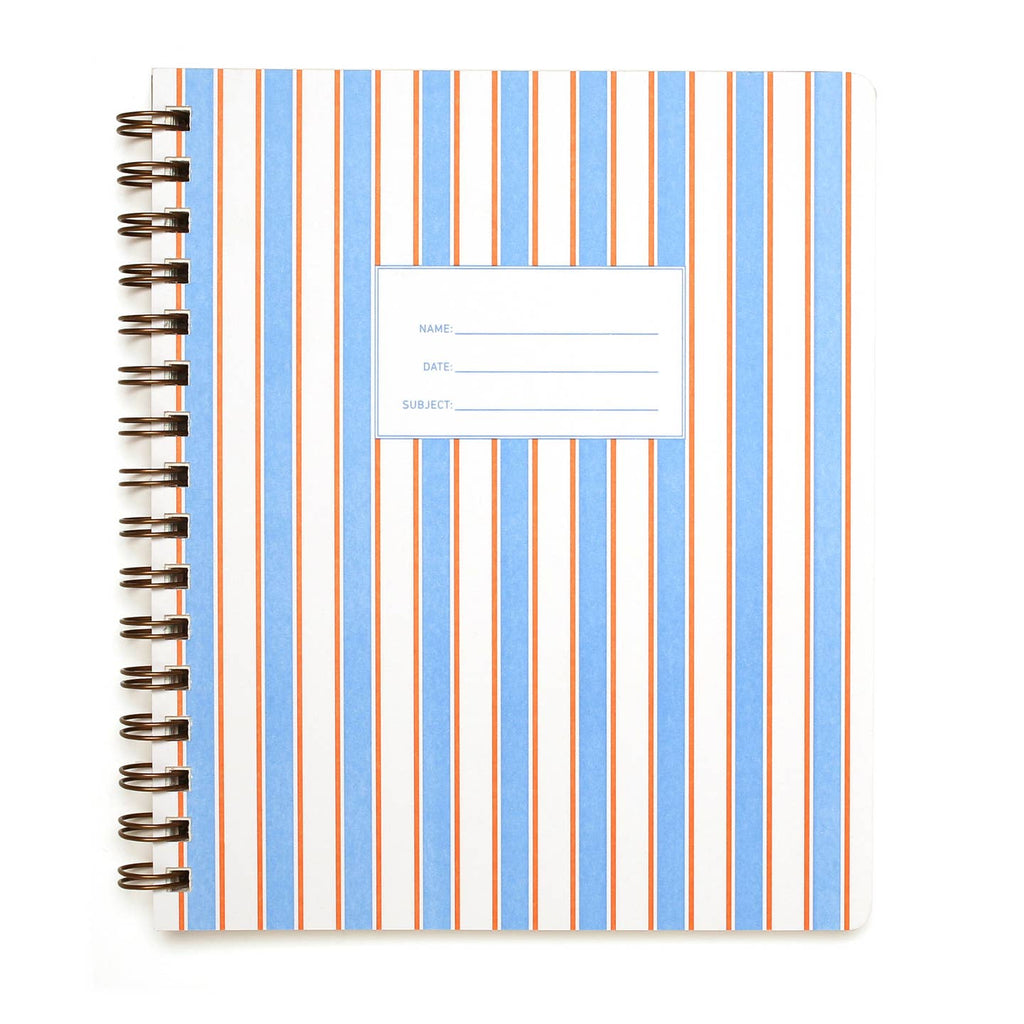 Notebook with vertical stripes in white, blue with smaller pink lines on each side. White rectangle with blue text says, "Name, Date, Subject". Coiled binding.