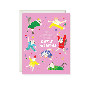 Pink background with images of cats wearing pajamas with white text says, "Hope your birthday is the cat's pajamas". White envelope included. 