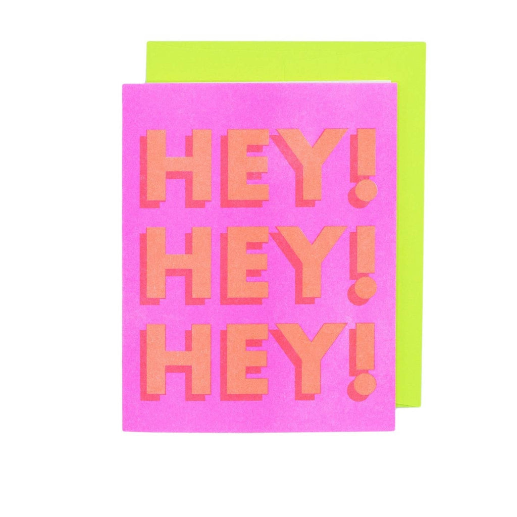 Greeting card with pink background and large orange text says, "Hey! Hey! Hey!". Neon envelope included.