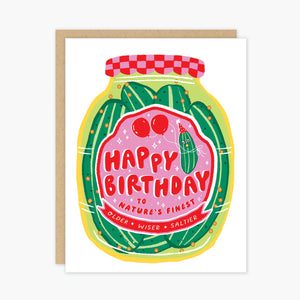 White background with image of jar of pickles in green and pink. Label on jar says, "Happy birthday to nature's finest, older, wiser, saltier". Kraft envelope included. 