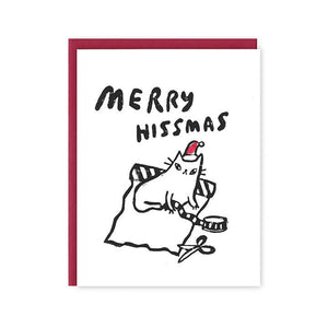 Greeting card with white background and image of a white cat wearing a red Santa hat with a roll of wrapping paper and tape. Black text says, "Merry Hissmas". Red envelope included. 