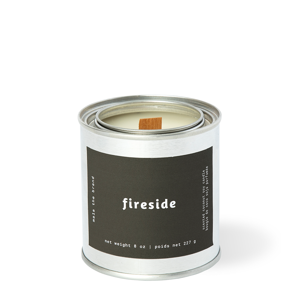 Image of candle with black label and white text says, "Fireside". 
