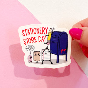 White background with image of stationery store day characters mailing a letter with red text says, " Stationery store day". 