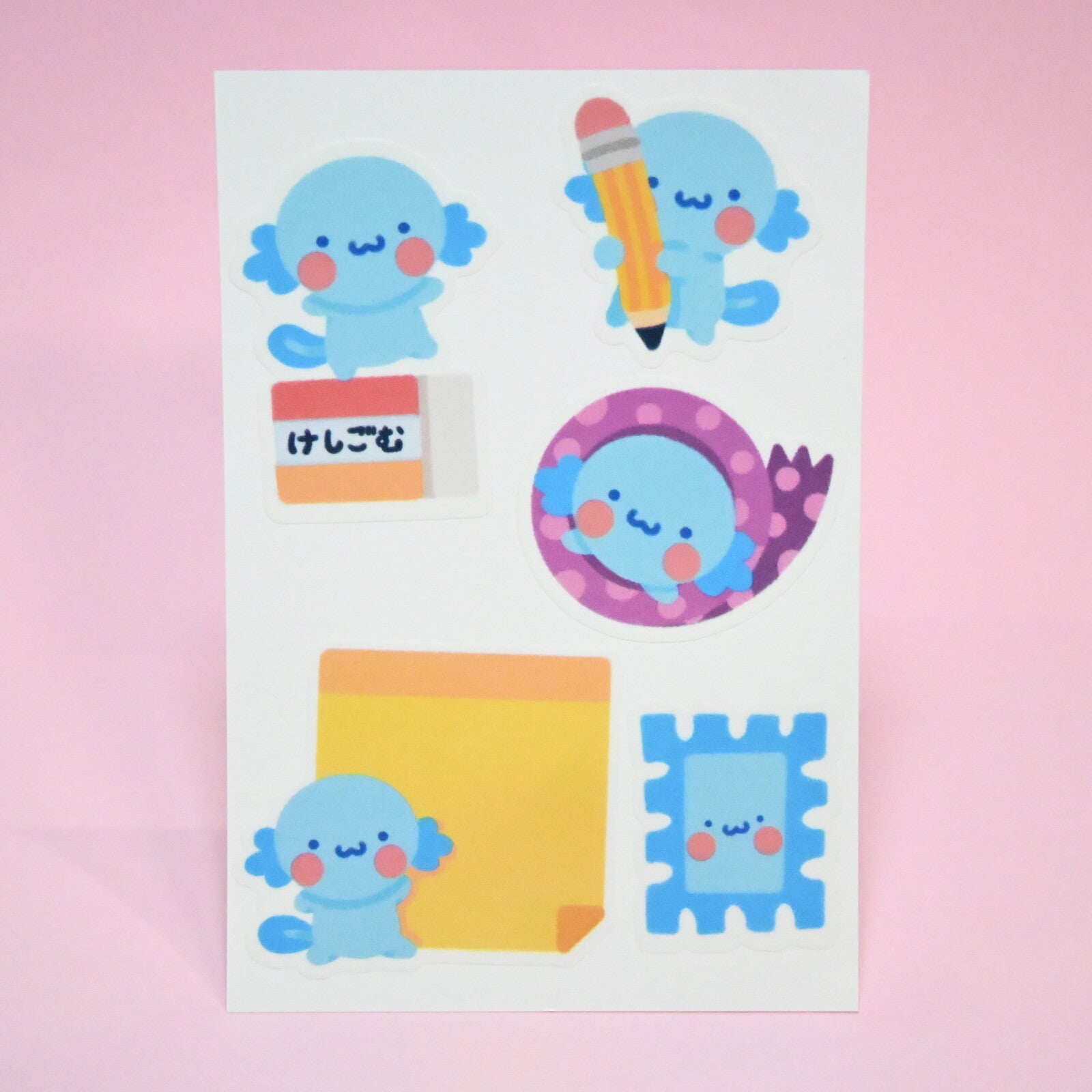 Package of stickers in the image of axoloti with stationery supplies.