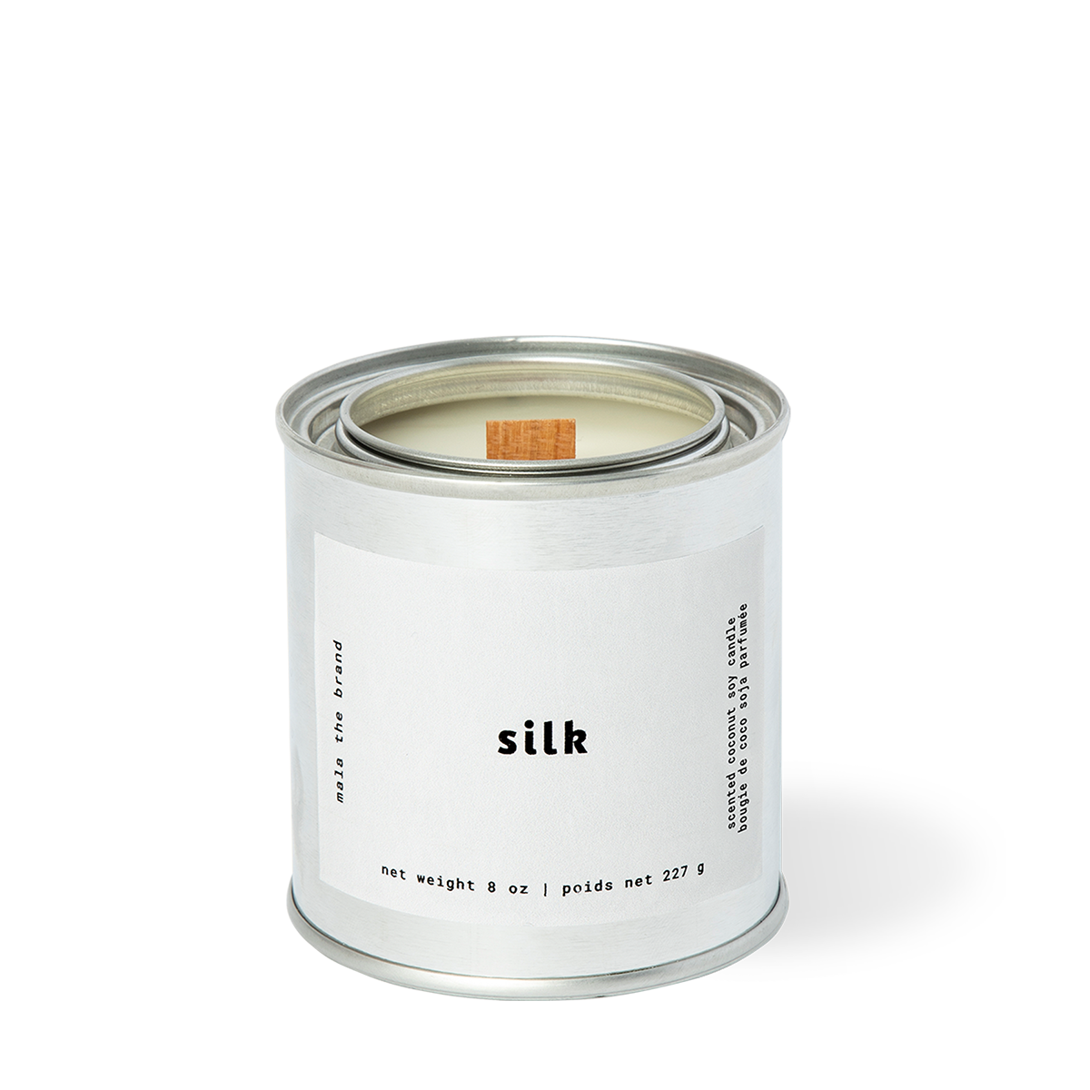 Image of candle with white label and white text says, "Silk". 