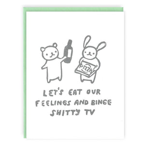 Greeting card with white background with image of bunny and bear holding a pizza box and a bottle of liquor. Grey text says, "Let's eat our feelings and binge shitty tv". Green envelope included. 