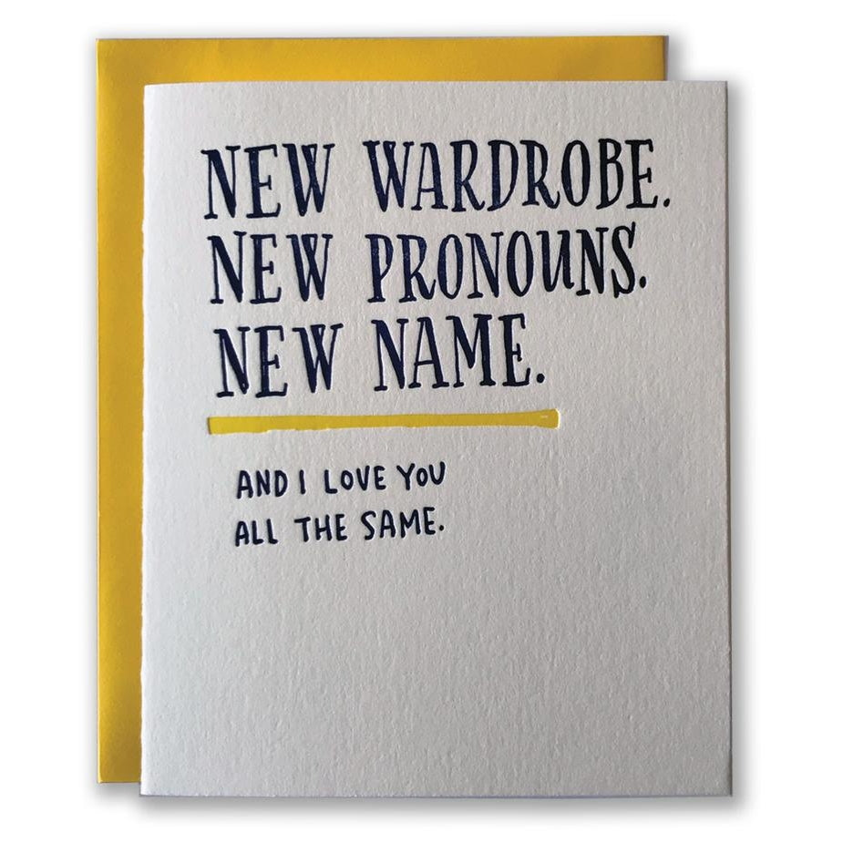 White card with black text saying, "New Wardrobe. New Pronouns. New Name. And I Love You All the Same."  A yellow envelope is included.