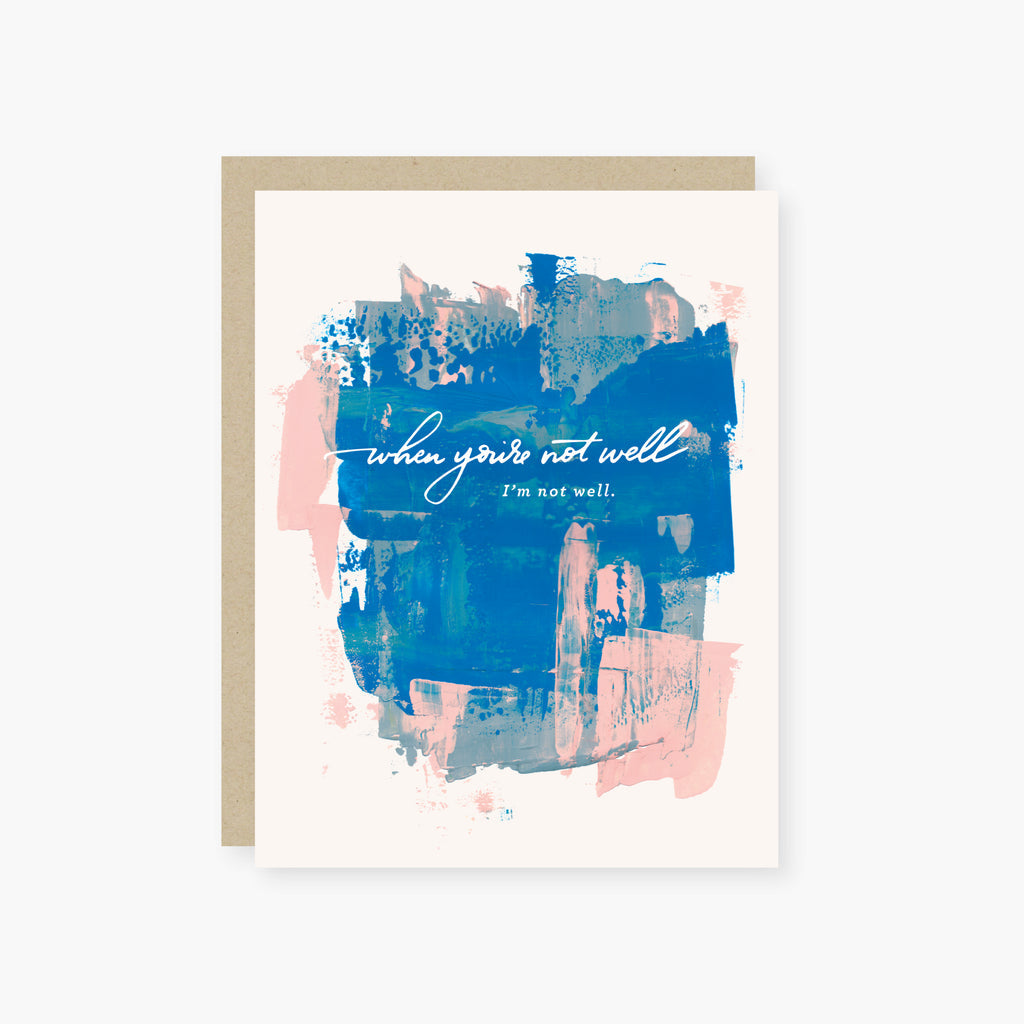 White card with white text saying, “When You’re Not Well I’m Not Well”. Image of blue and pink paintbrush strokes in background. A tan envelope is included.