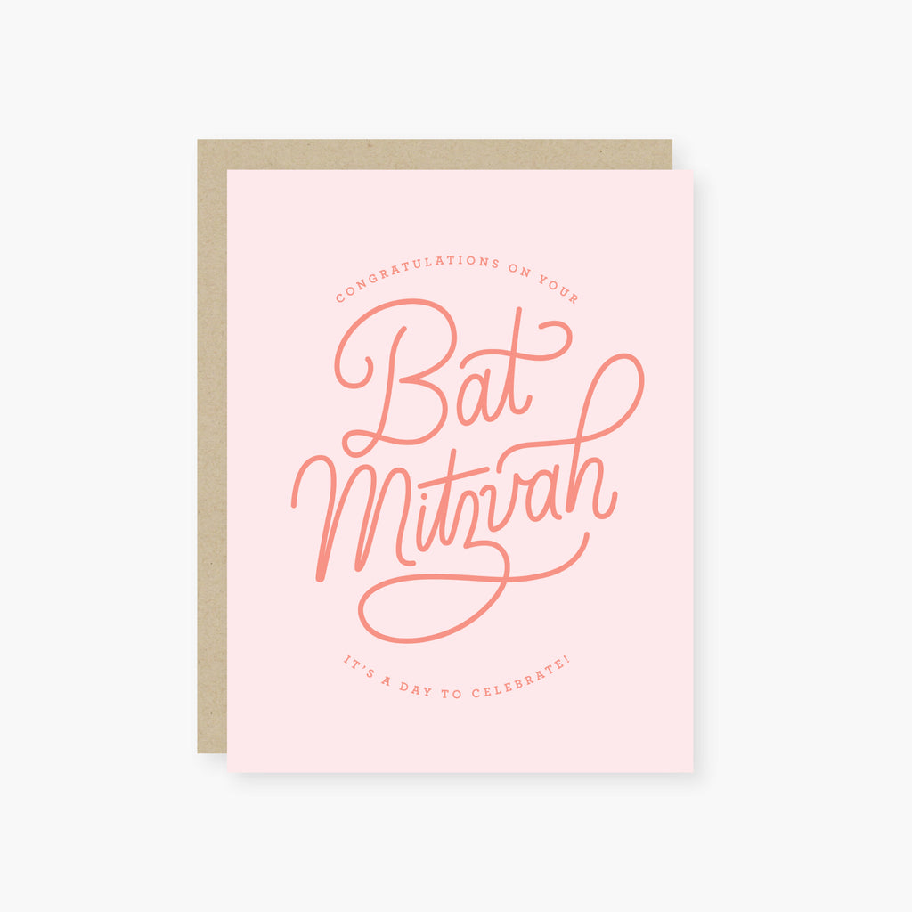 Pink card with dark pink text saying, “Congratulations on Your Bat Mitzvah It’s A Day to Celebrate!”  A gray envelope is included.