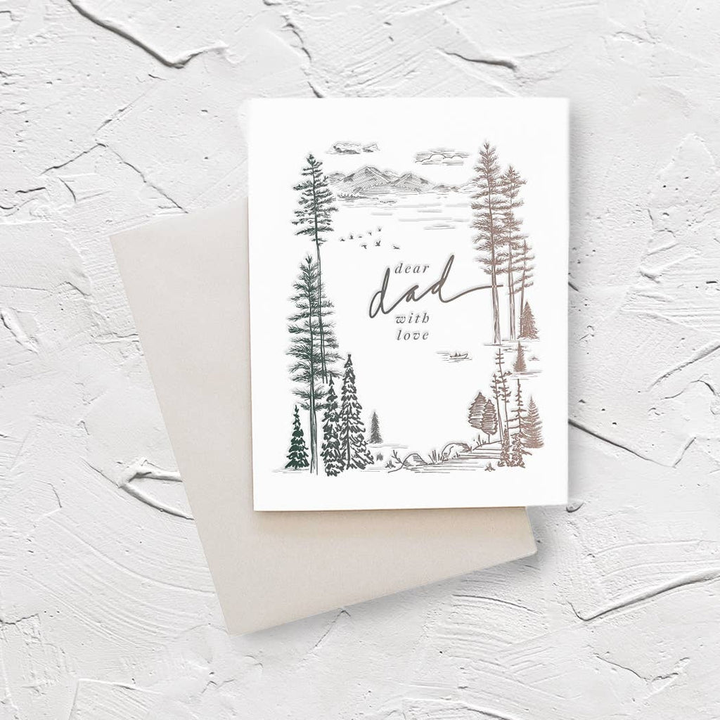 Ivory background with green, grey and silver images of trees, mountains, clouds and birds. Center text in grey says, “Dear Dad with love”. A silver envelope is included.   