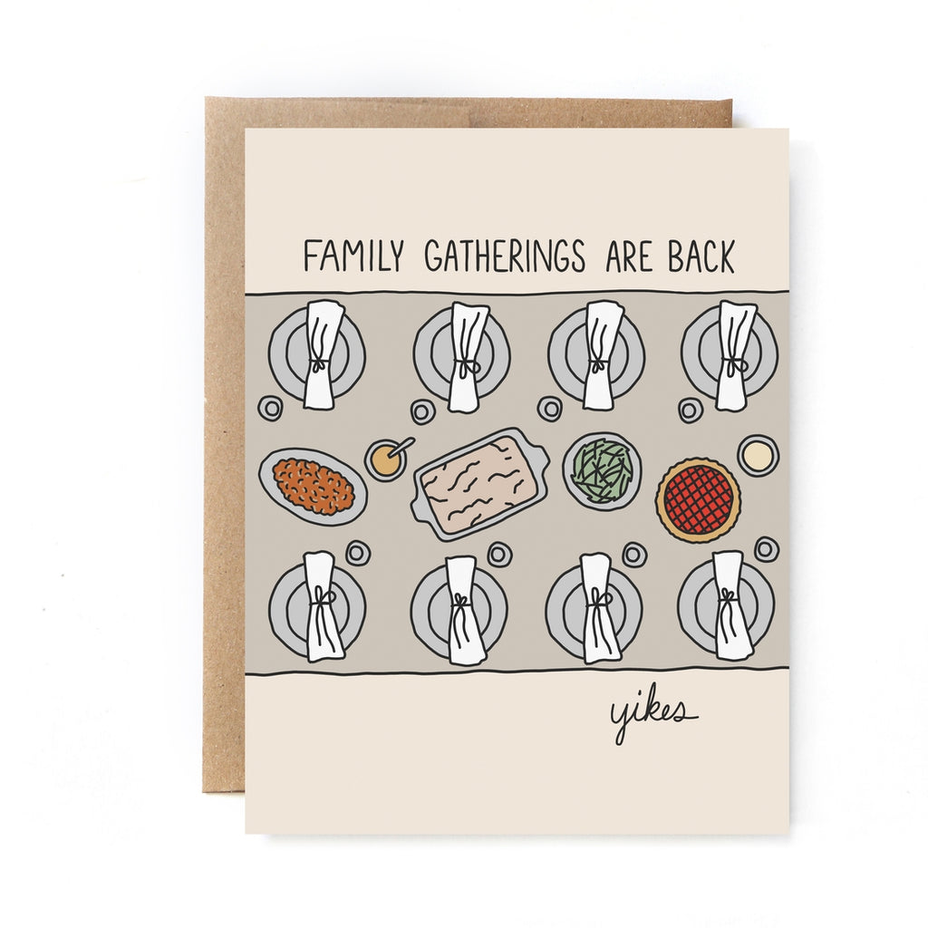 Tan card with black text saying, “Family Gatherings Are Back. Yikes.” Image of a family dinner table set up with plates, napkins, a casserole, vegetables, and pie. A brown envelope is included.