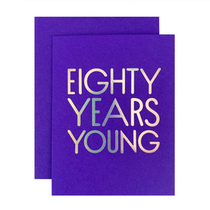 Blue card with silver foil text saying, “Eighty Years Young”. A blue envelope is included.