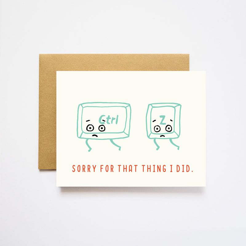 White card with red text saying, “Sorry for that Thing I Did”. Images of the computer keys Control and Z with sad faces. A gold foil envelope is included.