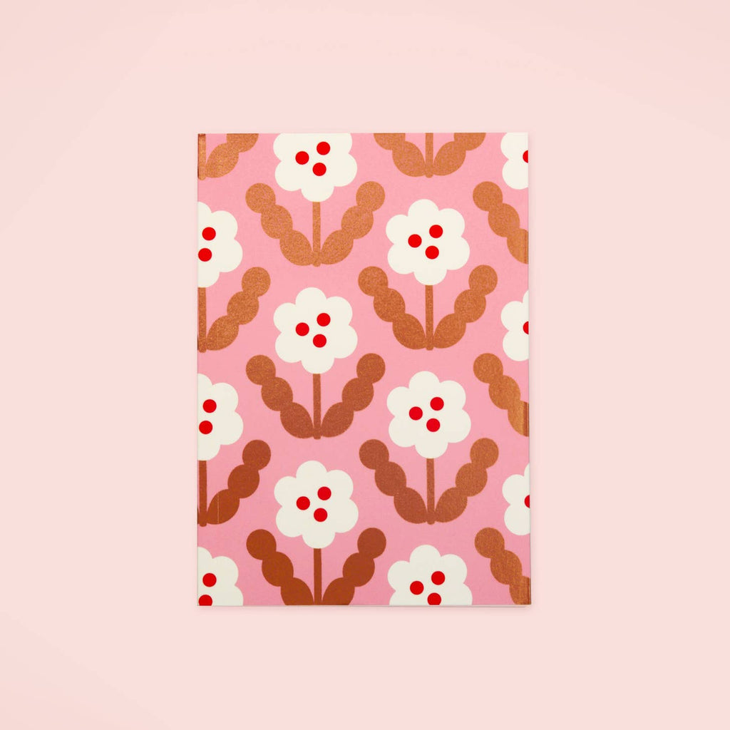 Pink background with images of white flowers with gold stems and leaves and three red dots in the center.  