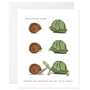 White background with brown text says, “Love can be scary. Thanks for bringing me out of my shell.” Three images of a brown snail and green turtle shell. First image is shells only, next image is heads poking out of the shells and final image is of the snail and the turtle fully out of their shells. An envelope is included.    