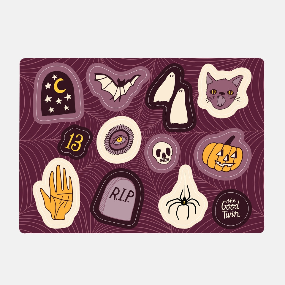 Purple background with Halloween images in ivory, orange and black including black sky with yellow moon and white stars, black and white bat, two white ghosts, a purple cat, a yellow number 13, a white skull, a jack o lantern, a black spider and a grave stone with RIP. 