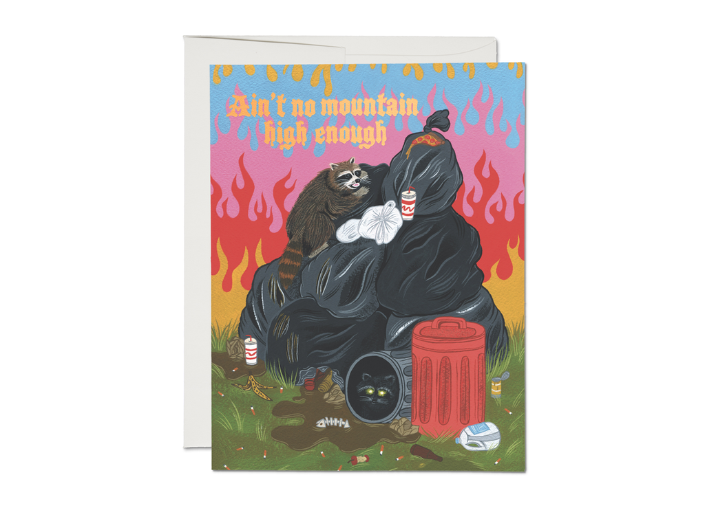Card with images of rainbow colored flames in background with a brown raccoon climbing on top of a pile of black garbage bags with trash on the ground and garbage cans scattered about. Peach text saying, “Ain’t No Mountain High Enough”. A white envelope is included.