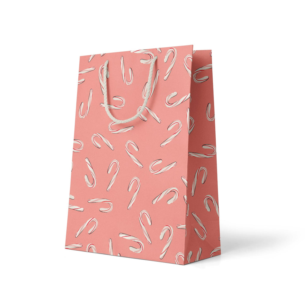 Pink bag with images of red and white candy canes on it. White rope handle.       