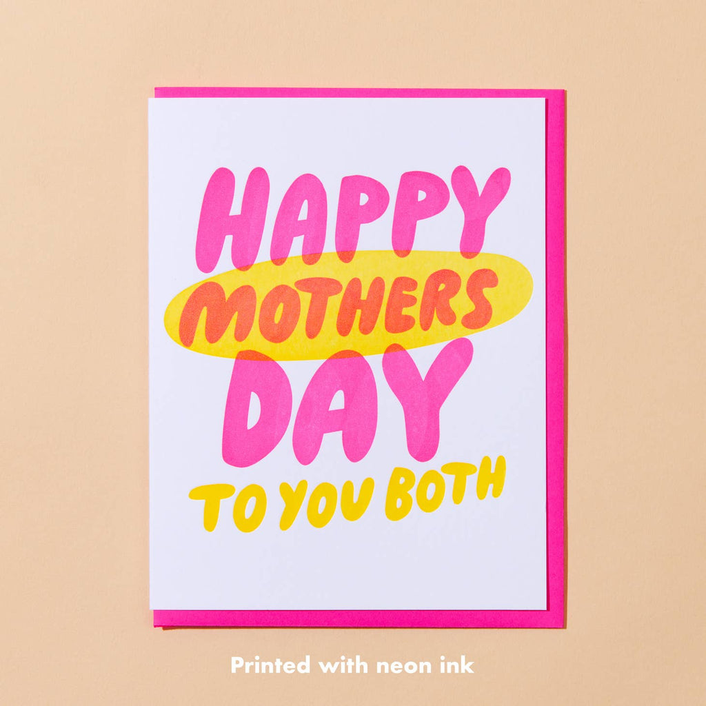 White card with neon pink and yellow text saying “Happy Mothers Day to you both”. Neon pink envelope is included.         