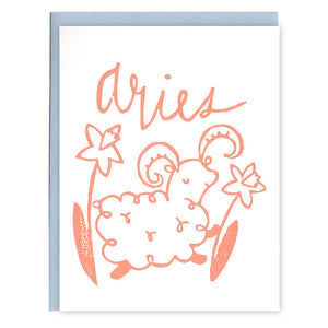 Ivory card with pink text saying, “Aries”. Image of the Aries ram zodiac sign. A light blue envelope is included.