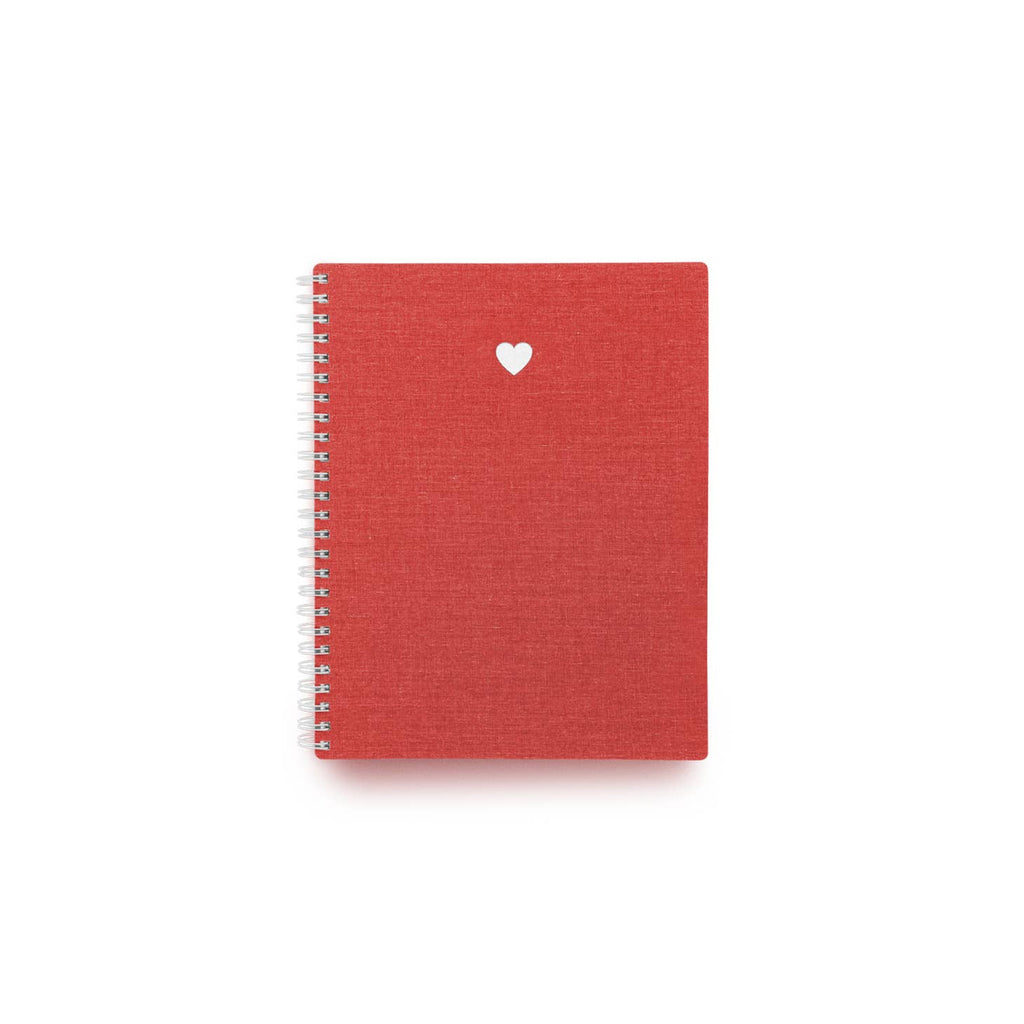 Red background with small white foil heart at top of notebook cover.