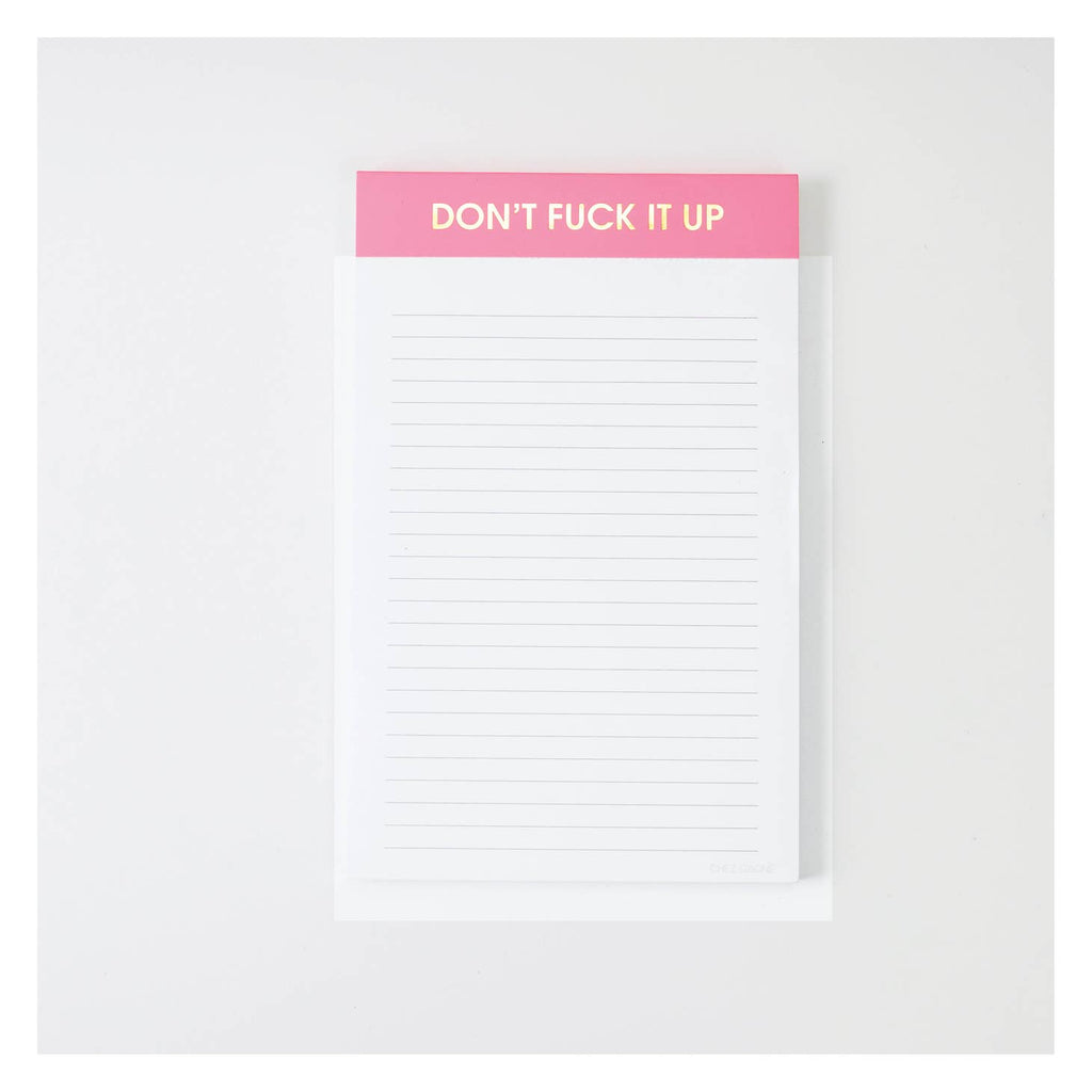 Image of a notepad with white lined paper a red binding with gold foil text says, “Don’t fuck it up”. 