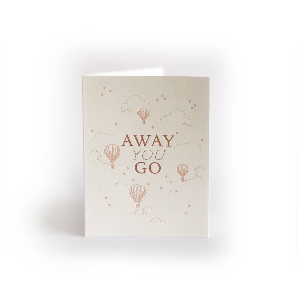 Ivory background with pink text says, ”Away you go” with pink images of hot air balloons, clouds and stars. An envelope is included. 
