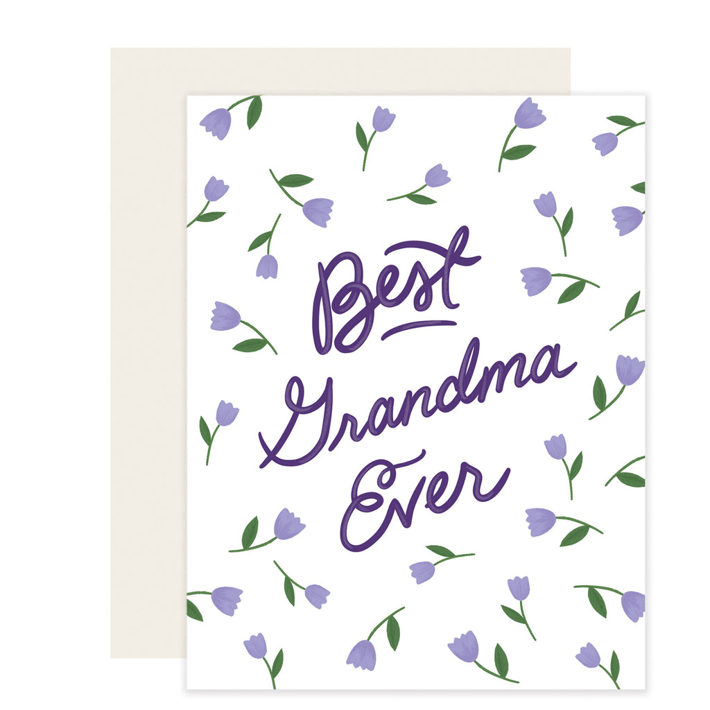 White card with purple text saying, “Best Grandma Ever”. Images of purple tulips scattered across card. An ivory envelope is included.