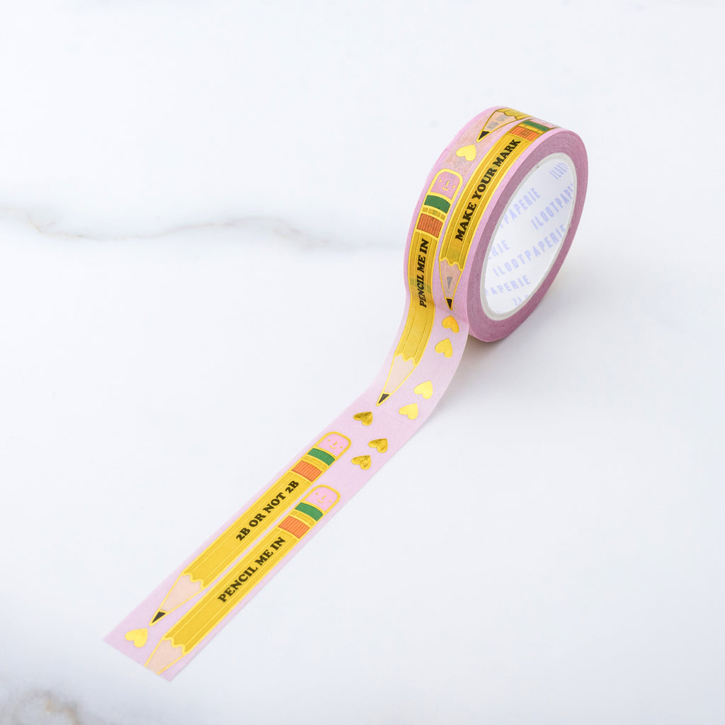 Decorative tape with light pink background with images of two yellow pencils with black text saying, "Pencil Me In 2B Or Not 2B" surrounded by small gold foil hearts.