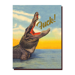 Card with image of a gray crocodile coming up out of the water with its mouth wide open. Goil foil text coming out its mouth saying, "Fuck!"  A brown envelope is included.