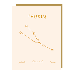 Ivory card with gold text saying, "Taurus Patient Determined Honest". Image of the Taurus Zodiac symbol. A gold envelope is included.