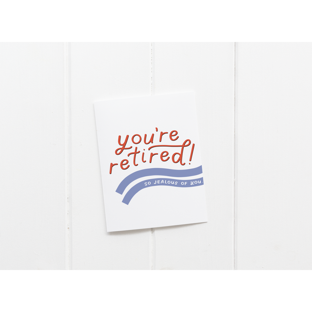White card with red and white text saying, "You're Retired! So Jealous of You". Images of two blue wavy lines across card. A white envelope is included.