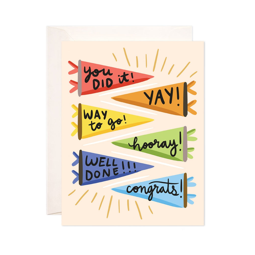 Cream card with black text saying, "You Did It! Yay! Way to Go! Hooray! Well Done! Congrats!" . Images of multicolored pennants displaying words. An ivory envelope is included.