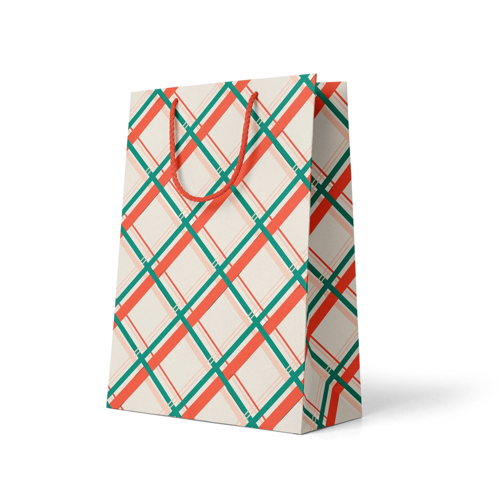 Ivory background with plaid design in red, green, orange, and pink. Red cord handle.         