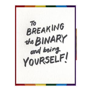 White card with black text saying, “To Breaking the Binary and Being Yourself”. A rainbow striped envelope is included.
