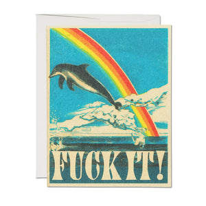 Ivory border with blue background with image of a grey and white dolphin with a rainbow in red, yellow, blue, and lavender and palm trees on a blue ocean and white clouds. Ivory text says, “Fuck it!”. A white envelope is included.         