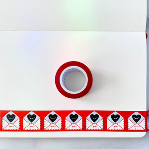 Decorative tape with red background with images of white mailing envelopes with dripping red blood and black hearts on the flap.