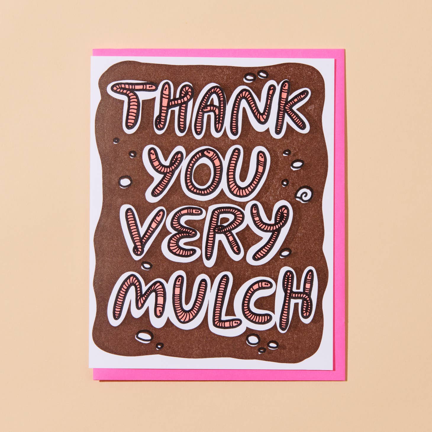 White card with image of a plot of brown dirt with pink worms that spell out “Thank you very mulch”.  Neon pink envelope included.       