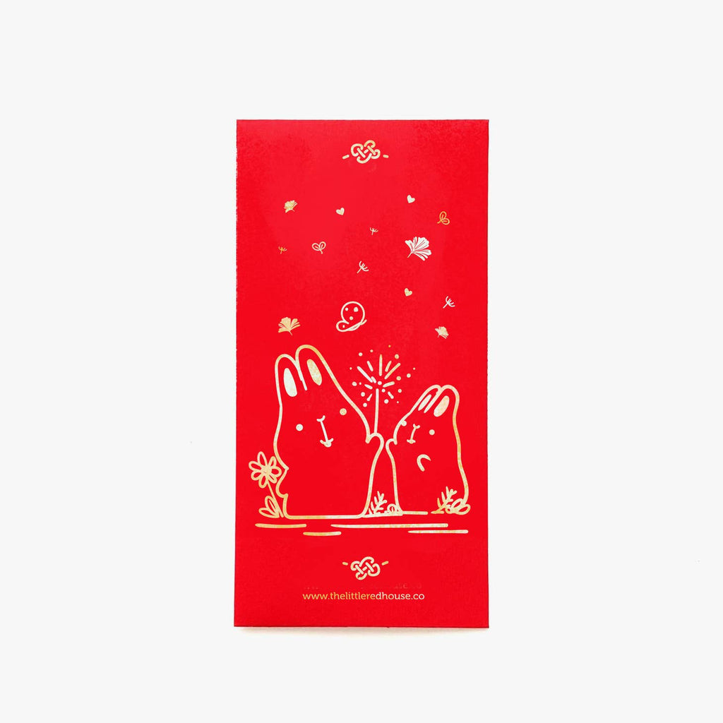 Image of red envelope with gold foil rabbits holding a sparkler. 