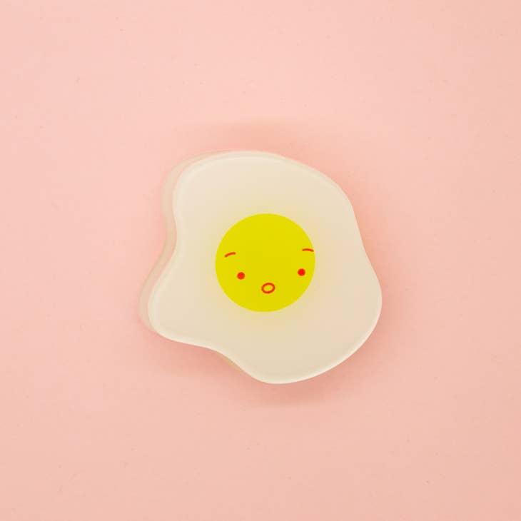 White egg with yellow yolk with red eyes, eyebrows and mouth.  